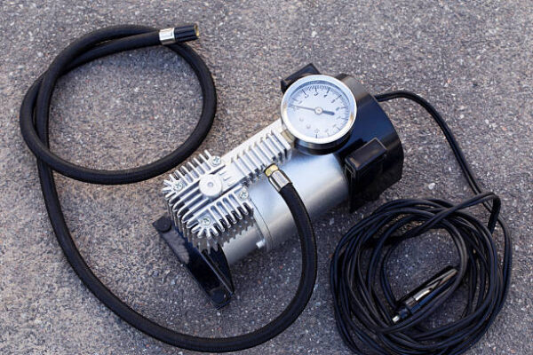 The pump to inflate automobile wheels lying on the floor