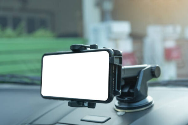 Gps navigation in mobile phone while driving car at sunrise