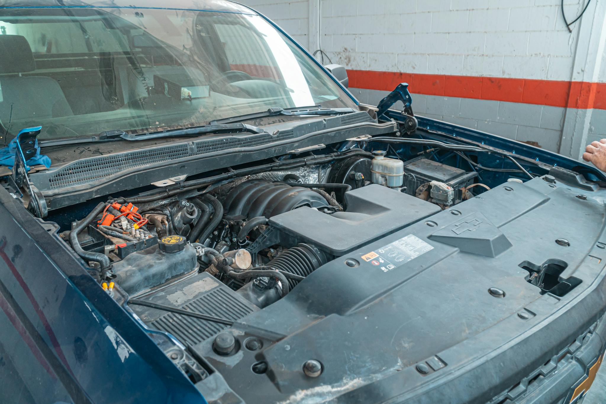 Close-up image of a car engine being repaired in a garage workshop. Ideal for automotive themes.